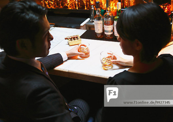 Couple drinking in a fashionable bar