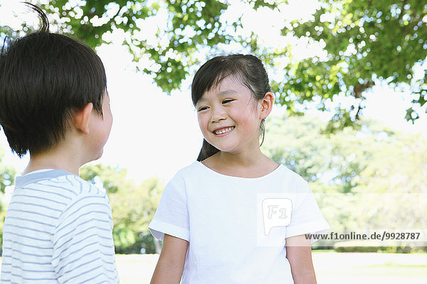 Happy Japanese kids in a city park