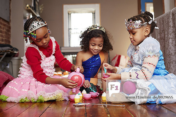 Girls playing dress-up at tea party