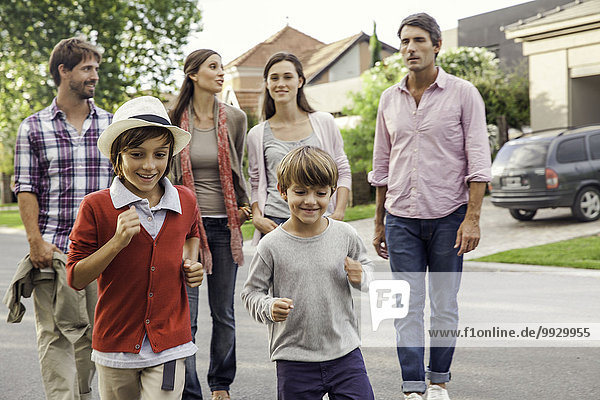 Family walking together through suburban neighborhood