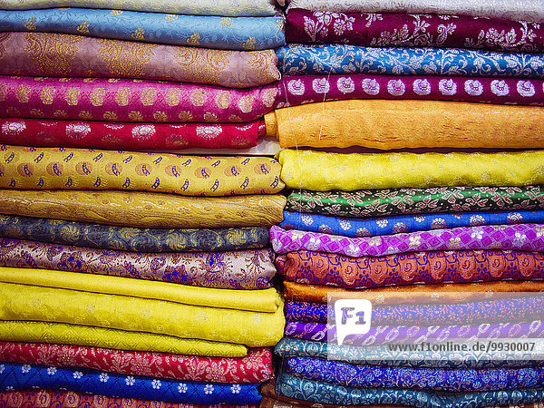 Close up of piles of multicolor fabrics