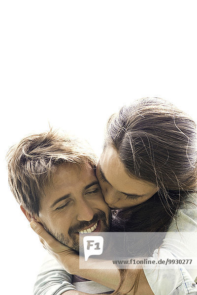 Young woman kissing boyfriend