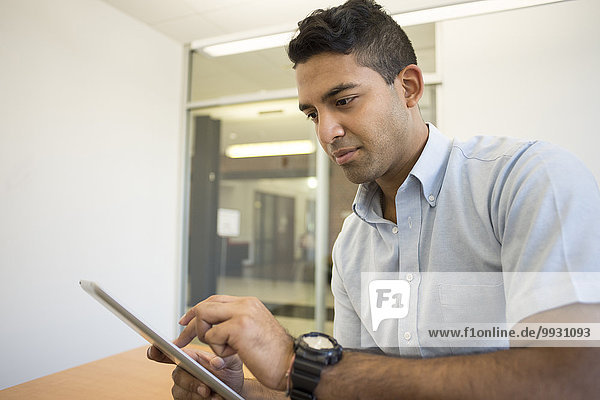 Asian businessman using digital tablet in office
