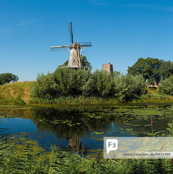 Netherlands  Holland  Europe  Woudrichem  Tower windmill  windmill  city  village  water  trees  summer