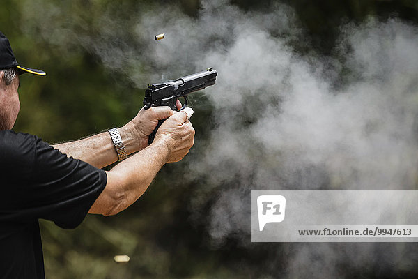 Man shooting a gun  Rio de Janeiro  Brazil  South America
