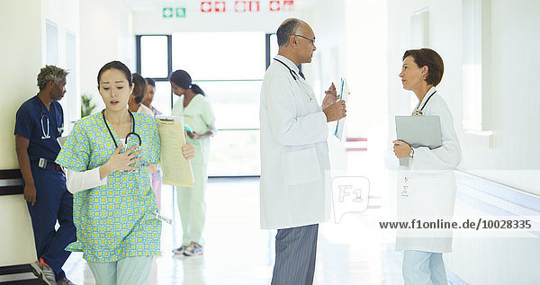 Doctors talking in hospital corridor