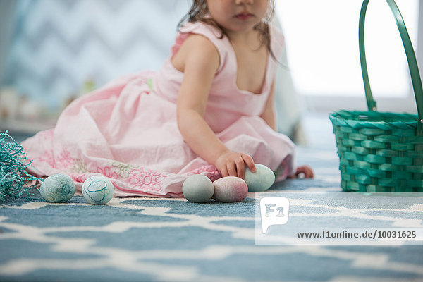 Girl in pink dress with Easter eggs
