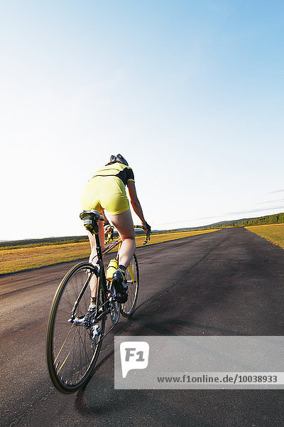 Woman cycling  rear view