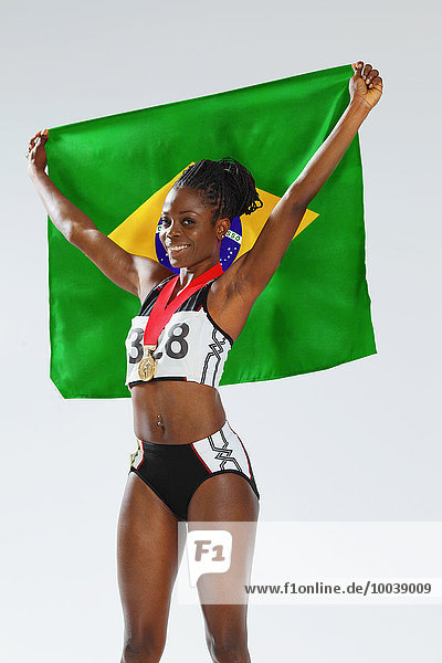 Female Athlete Holding a Brazilian Flag