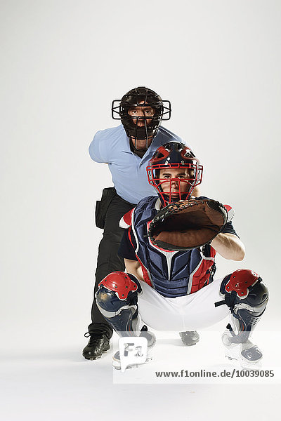 Baseball catcher and chief referee against white background