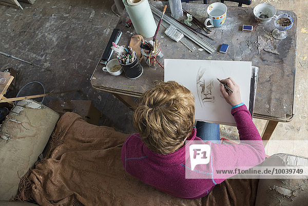 Female artist making sketch in art studio Bavaria Germany