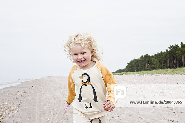 Happy girl walking on beach