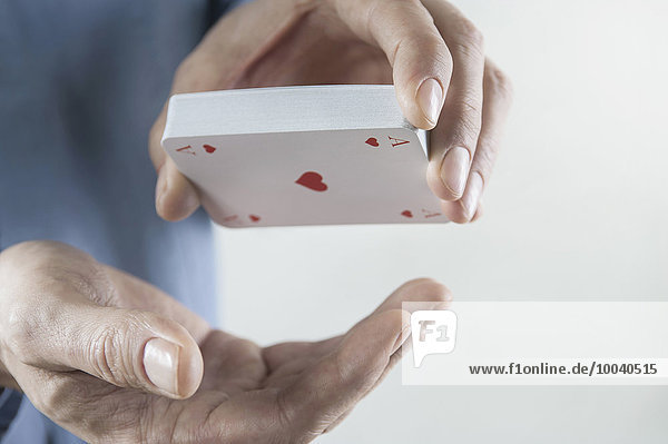 Man's hand holding deck of playing cards  Bavaria  Germany