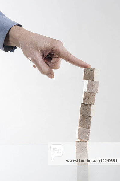 Man's hand stacking of the last block  Bavaria  Germany