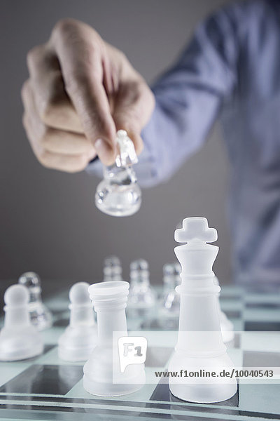 Close-up of man's hand going for checkmate while playing chess  Bavaria  Germany