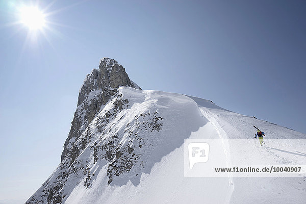 Ski mountaineer climbing on snowy peak  Tyrol  Austria