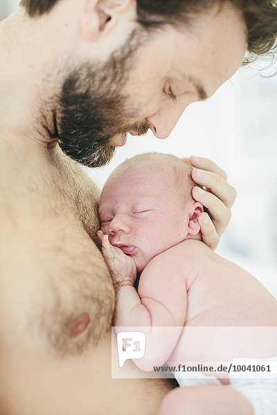 Mid adult man with newborn baby