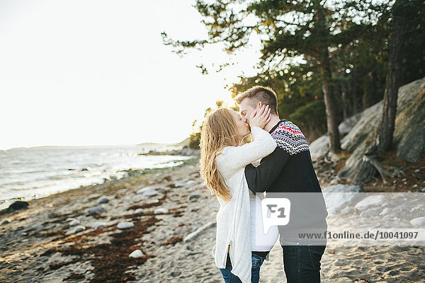 Young couple kissing on beach