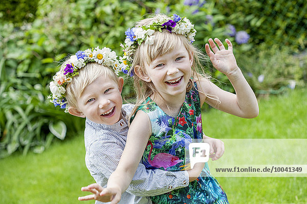 Brother and sister wearing flower wreaths