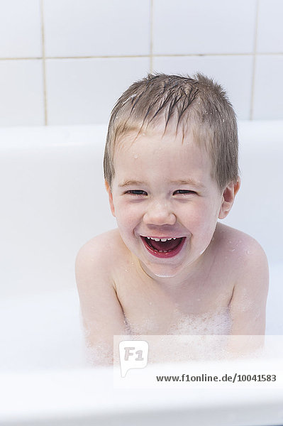 Laughing boy having bath