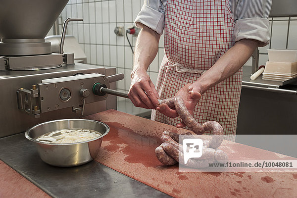 Preparation of smoked sausage  Butcher filling sausage casing