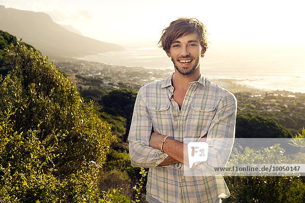 Portrait of smiling young man at the coast