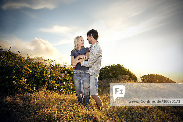 Young couple embracing in remote landscape