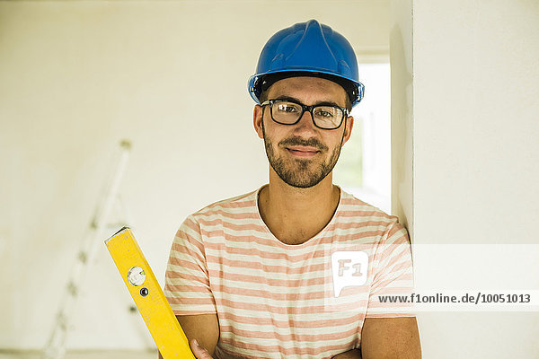 Portrait of smiling young man wearing hard hat