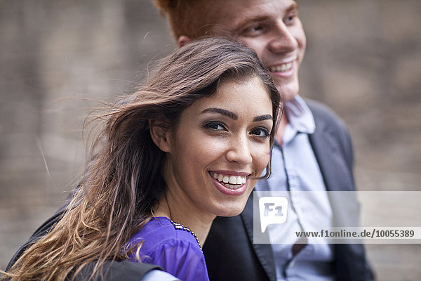 Young couple standing together  outdoors  looking away  smiling
