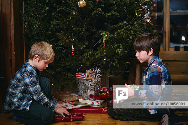 Two brothers opening Christmas presents