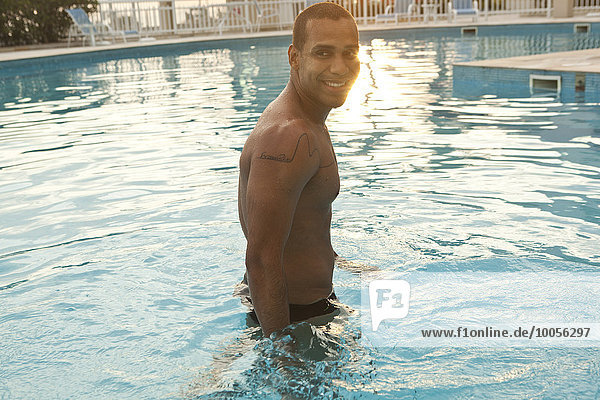 Mid adult man standing in hotel swimming pool  Rio De Janeiro  Brazil