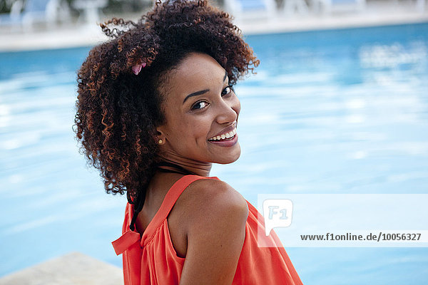Portrait of young woman sitting at hotel poolside  Rio De Janeiro  Brazil