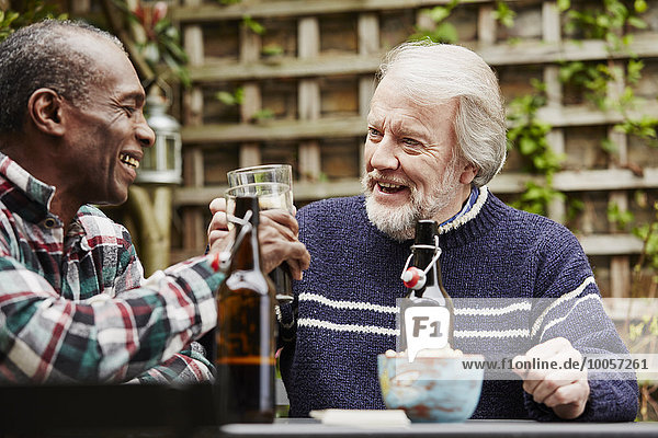 Two senior men drinking beer