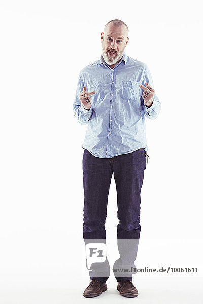 Mature man making obscene gesture with hands  white background