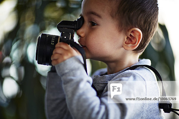 Boy taking photograph with camera