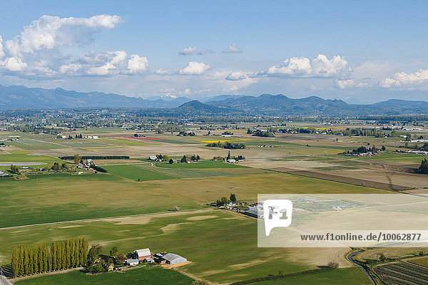 Aerial view of valley fields and distant mountains