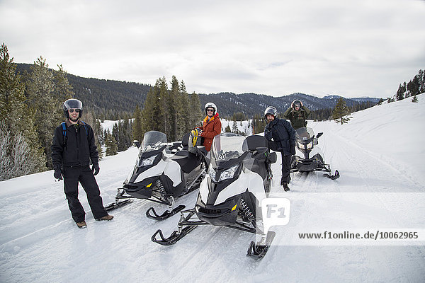 Friends on snowmobile  Jackson Hole  Wyoming