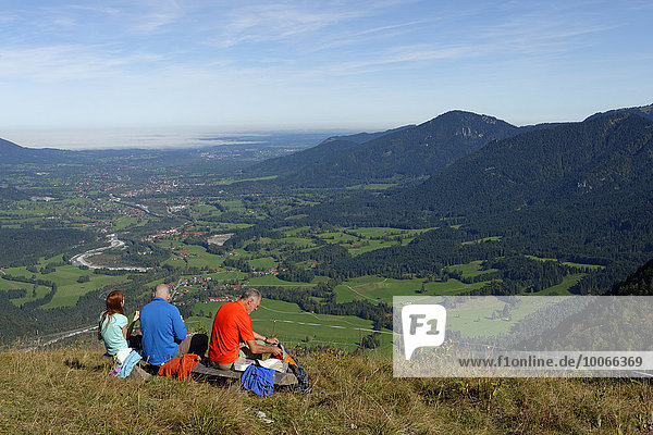 Hikers having a rest on the way to the Hochalm  Isarwinkel  Tölzer Land  Upper Bavaria  Bavaria  Germany  Europe