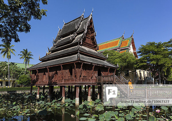 Mönch vor dem Wat Thung Si Mueang  Klosterbibliothek  Lotusteich  Muang  Ubon Ratchathani  Isan  Isaan  Thailand  Asien