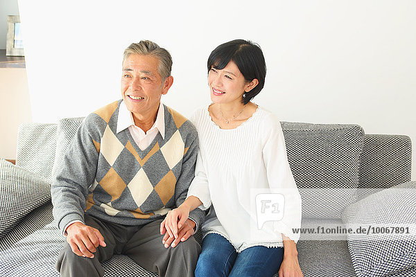 Japanese senior and daughter on the sofa