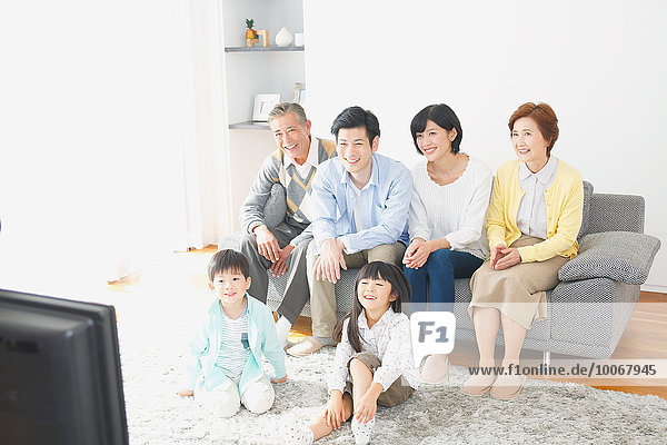 Three-generation Japanese family on the sofa in the living room