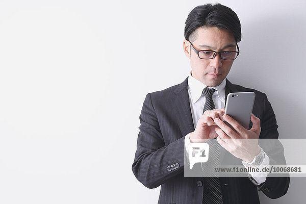 Japanese businessman working with large display smartphone