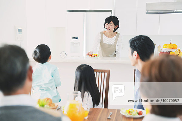 Three-generation Japanese family together in the kitchen