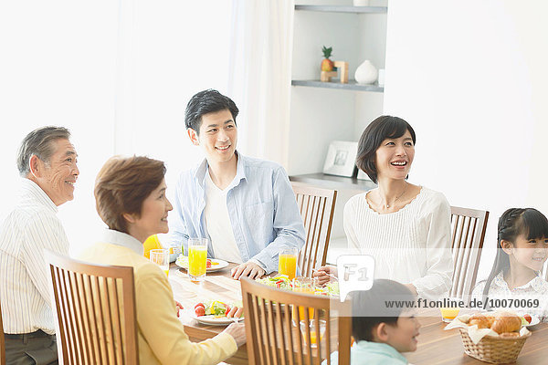 Three-generation Japanese family together in the kitchen