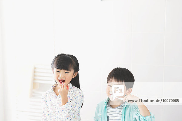 Japanese kid brushing teeth in the bathroom