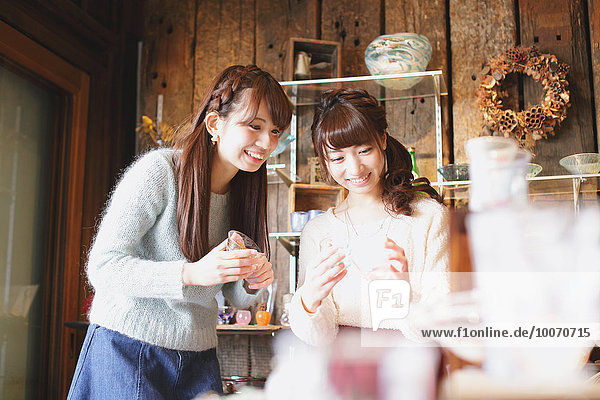 Young Japanese women enjoying visit to glass workshop in Kawagoe  Japan
