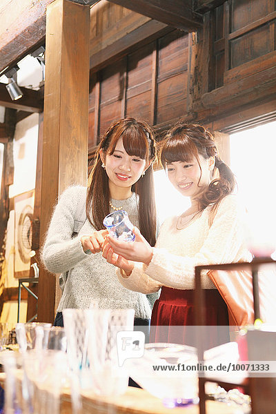 Young Japanese women enjoying visit to glass workshop in Kawagoe  Japan
