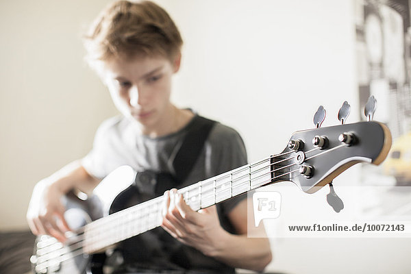 Teenage boy playing a guitar
