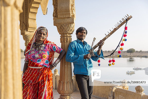 Traditional Indian couple standing in monument  Jaisalmer  Rajasthan  India