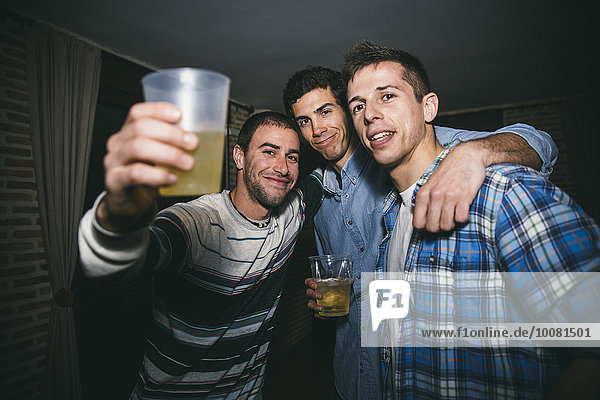 Smiling men drinking in nightclub